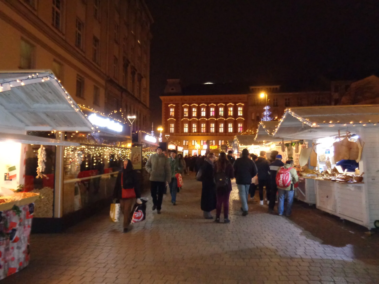 Advent market cabins and evening visitors on Europe Square in Zagreb