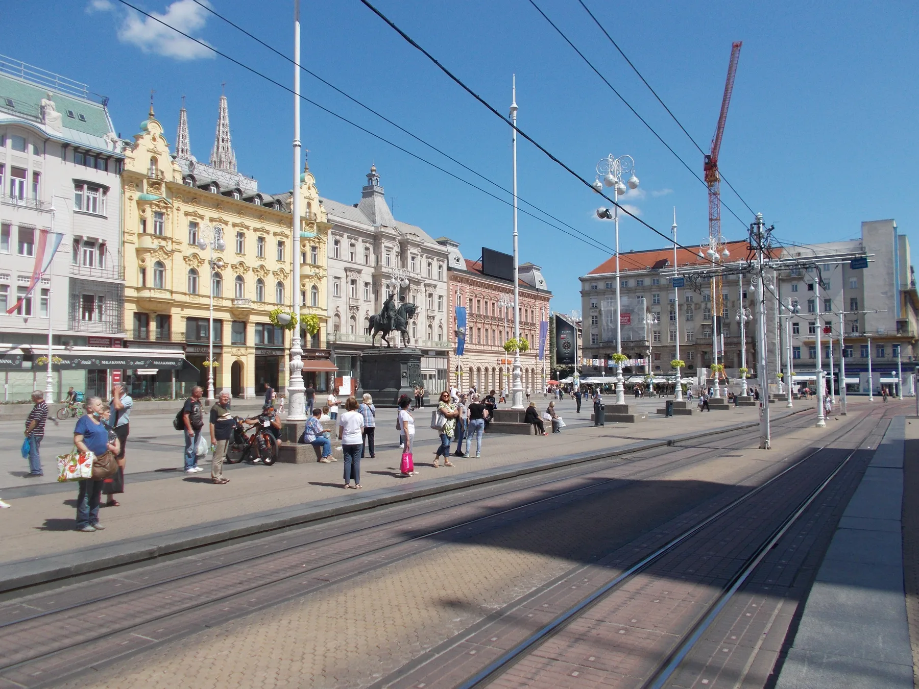 Wide 2021 view across Ban Jelacic Square with tram rails, statue and surrounding buildings