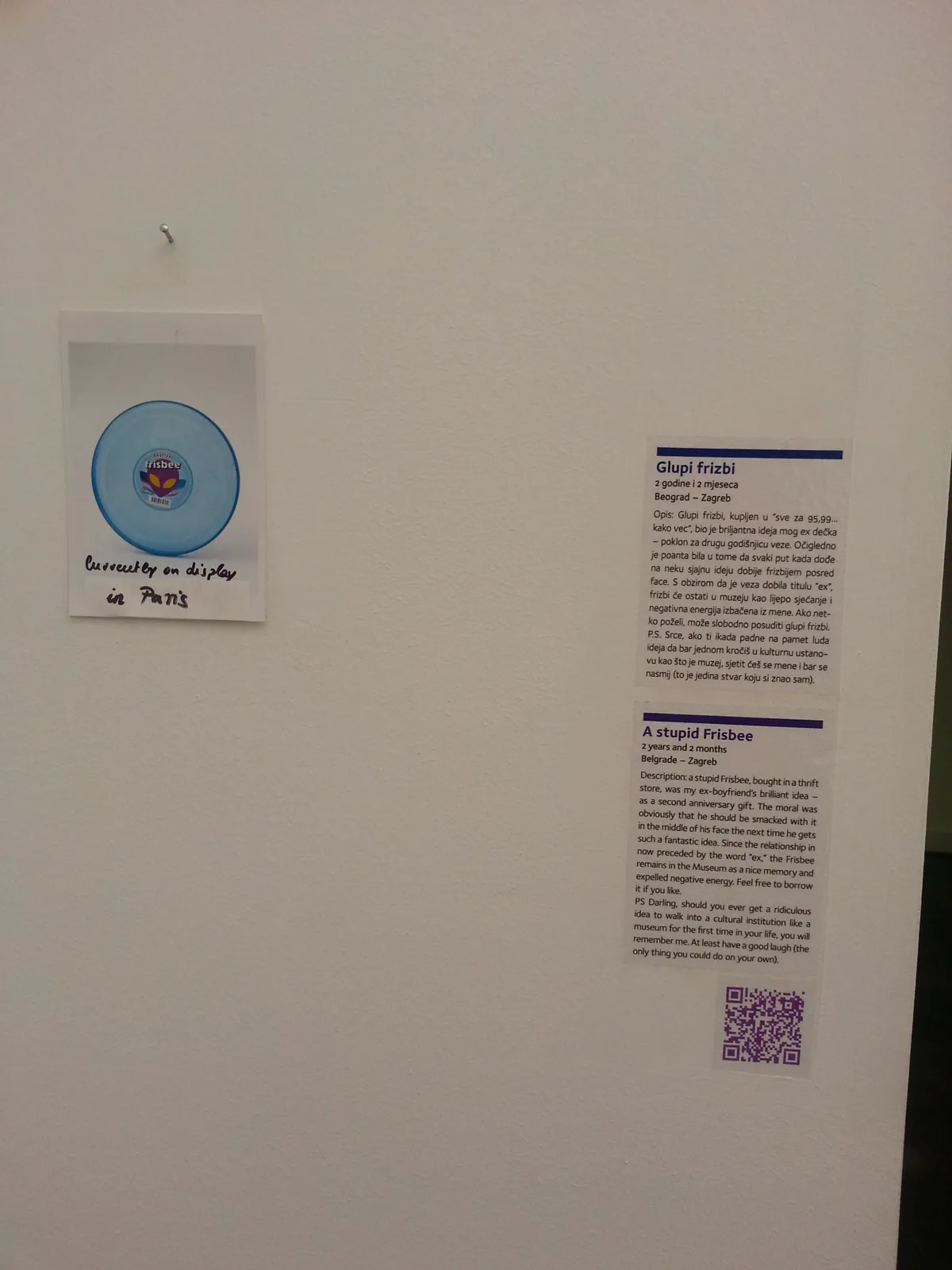 Small donated pin displayed with a relationship story in the Museum of Broken Relationships