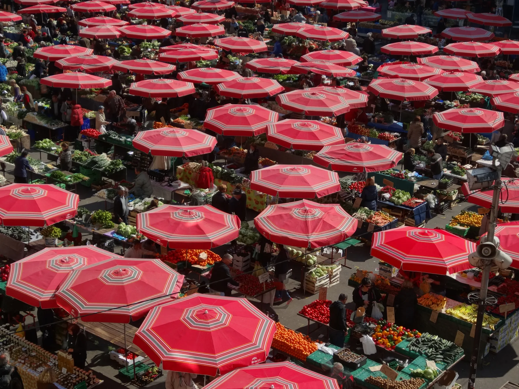 Overhead view of Dolac Market's red umbrellas and tightly arranged produce stalls