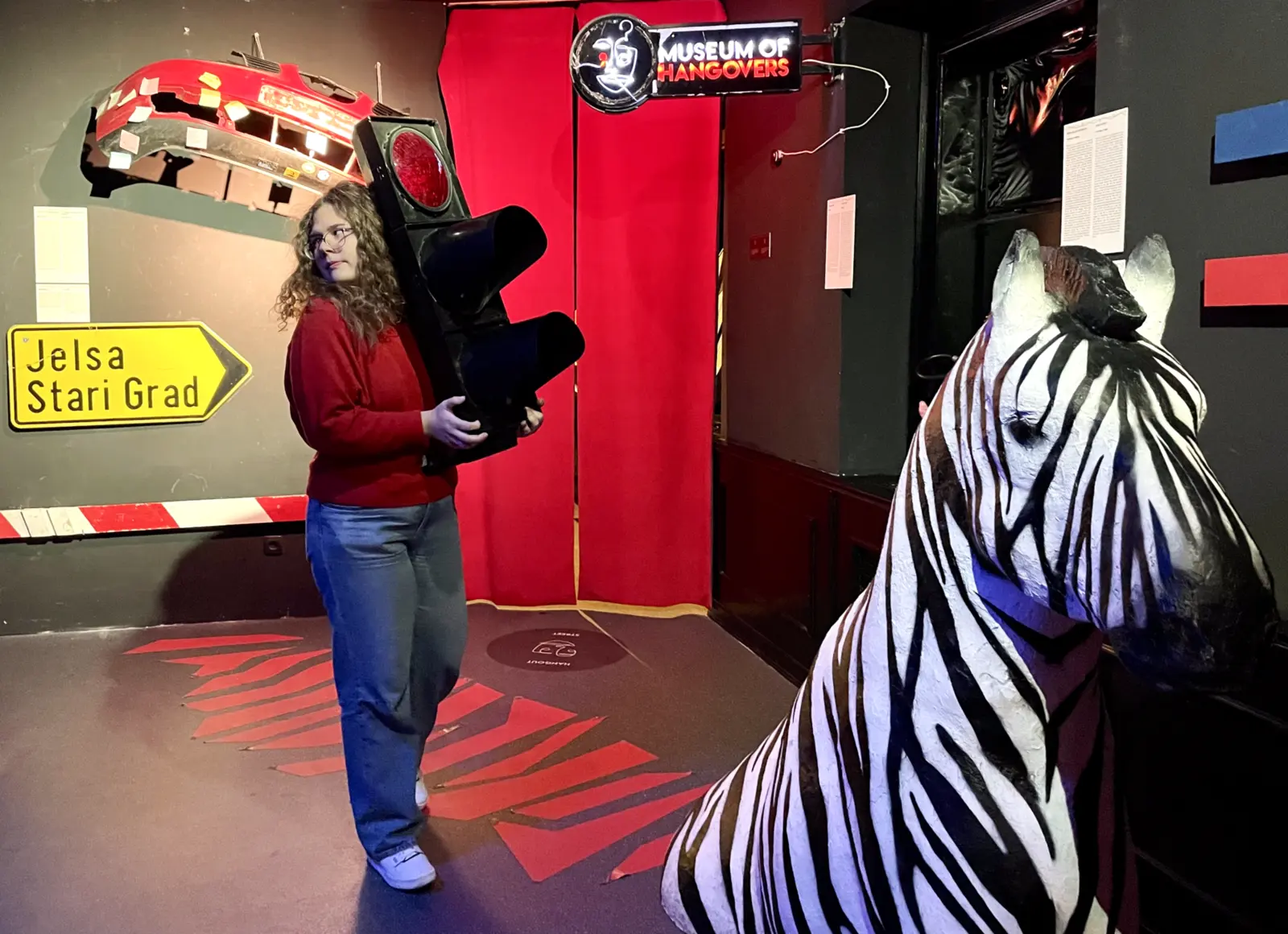 Visitor among interactive displays inside Zagreb Museum of Hangovers
