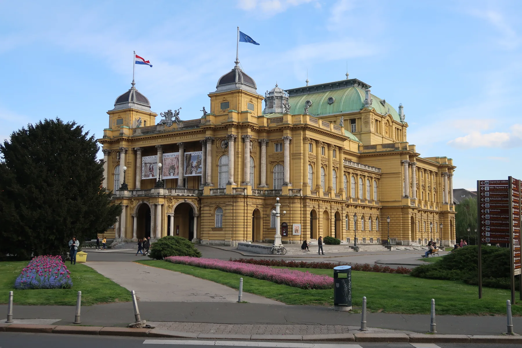 Croatian National Theatre viewed across lawns and flower beds in April 2022