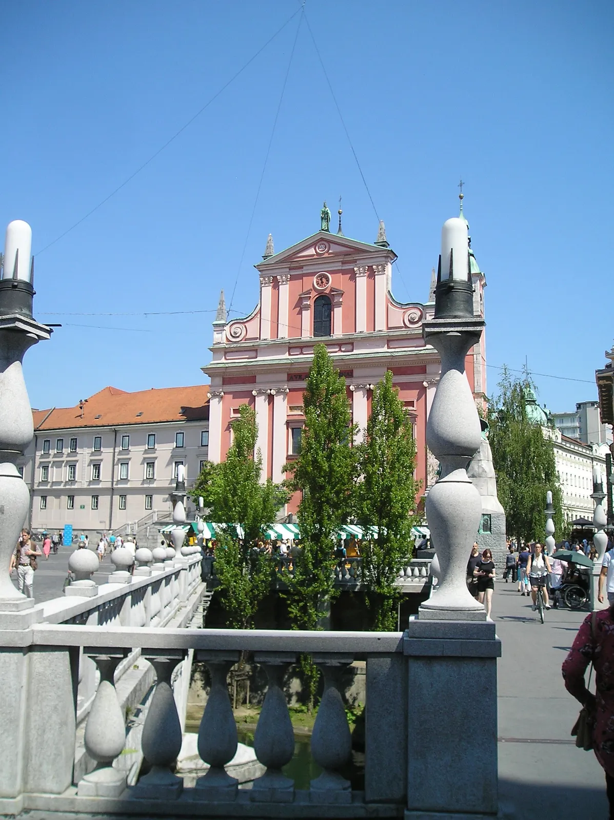 Triple Bridge leading towards the pink Franciscan Church at Prešeren Square in Ljubljana