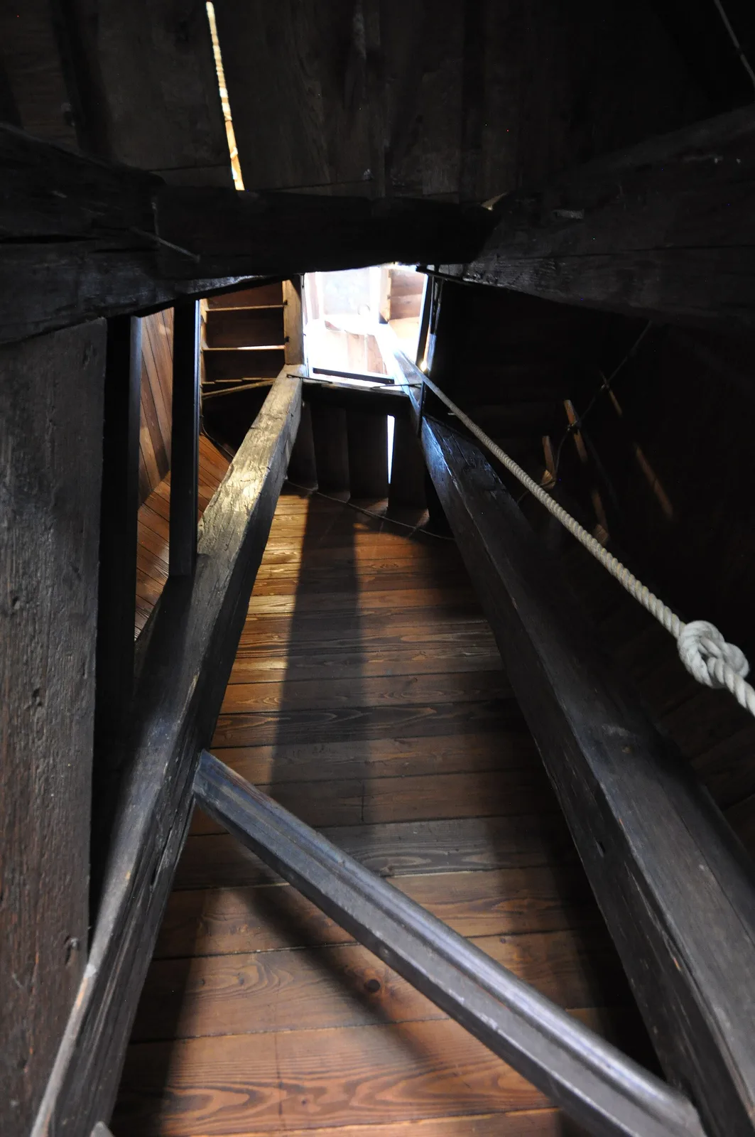 Narrow wooden stairs climbing inside Lotrscak Tower