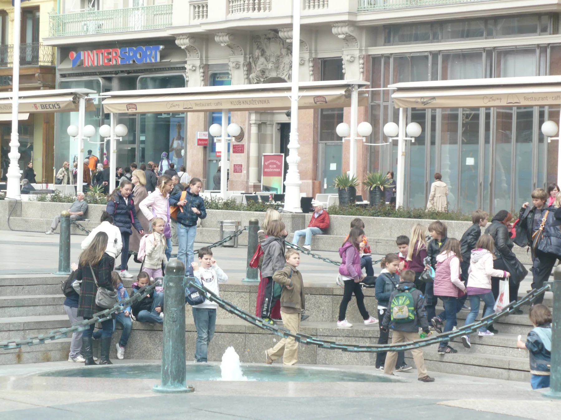 People gathered around Manduševac within the larger Ban Jelacic Square
