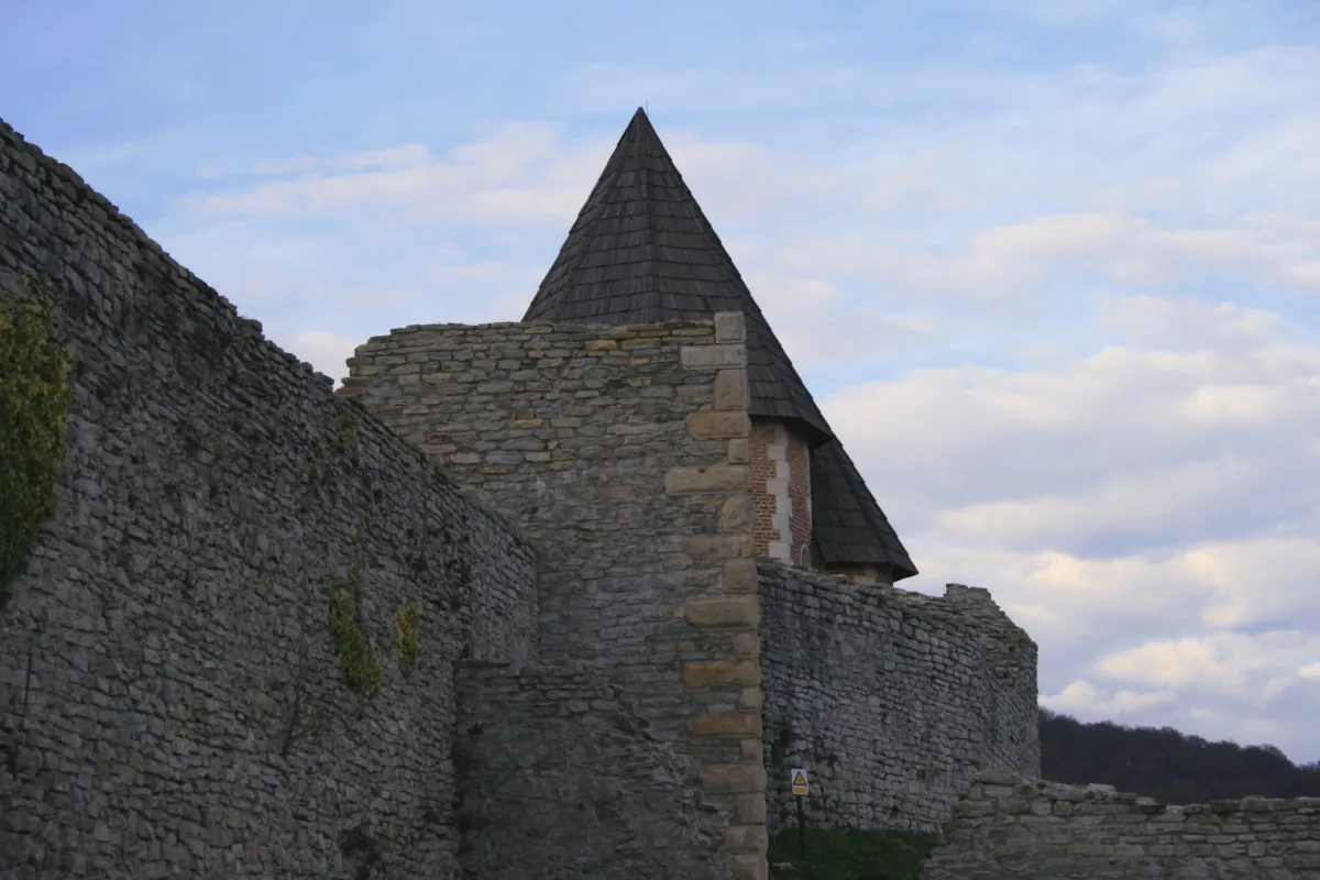 Conserved stone walls and a steep-roofed structure inside Medvedgrad