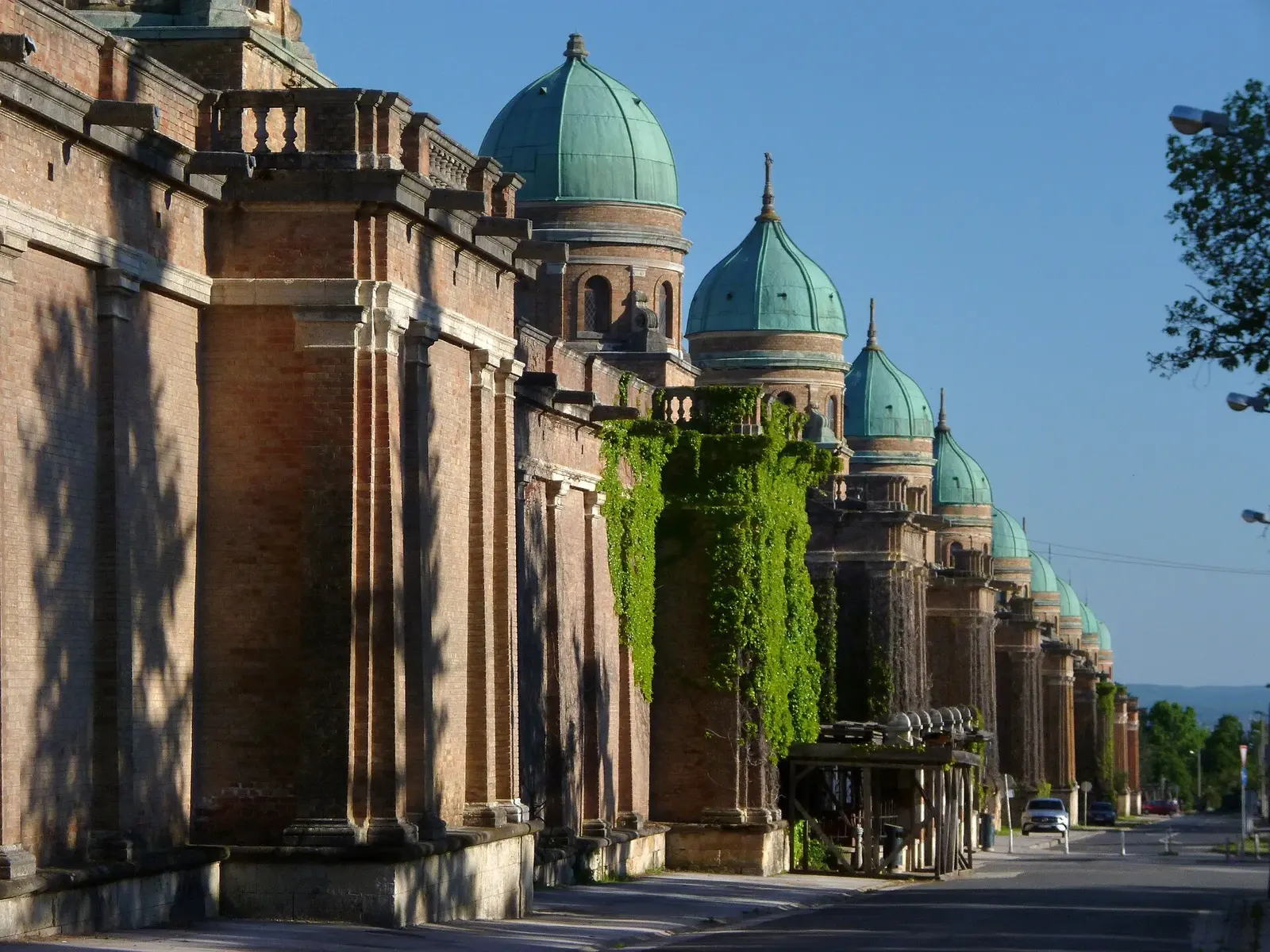 Ivy-covered brick arcades and green domes along Mirogoj Cemetery