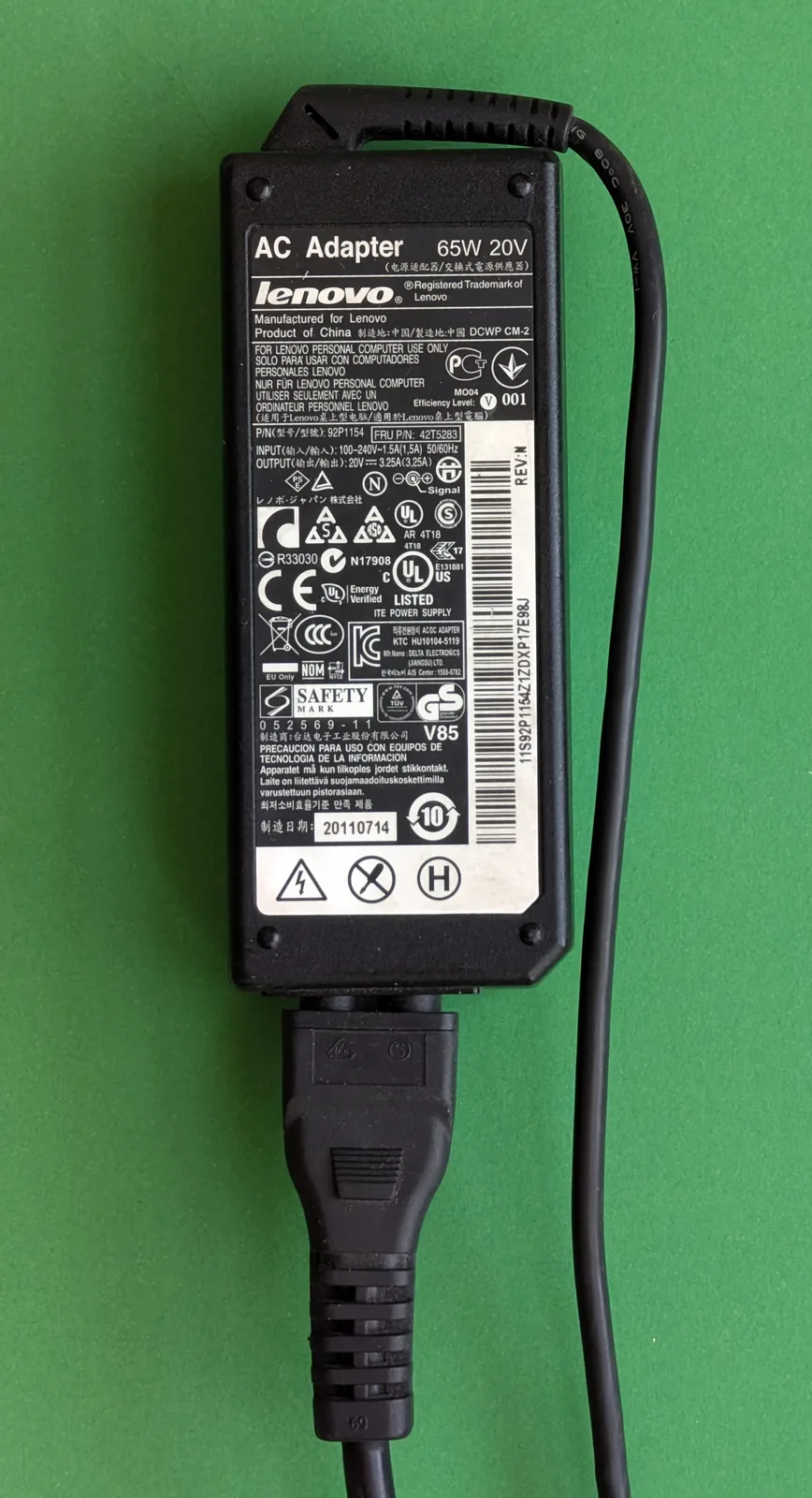 Laptop power supply with its electrical input and output specifications printed on the label