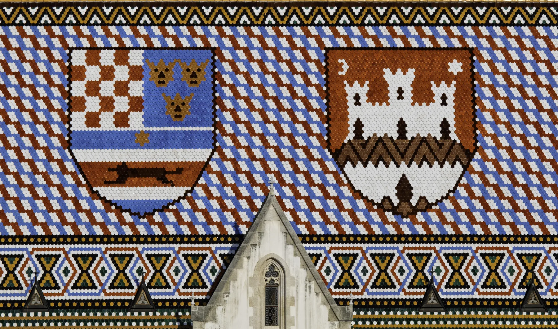 Close view of St Mark's Church tiled roof with its heraldic coats of arms