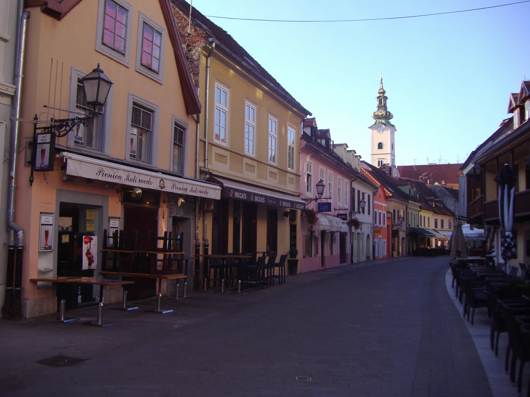 Nearly empty Tkalčićeva Street at early morning with terraces closed and tower ahead