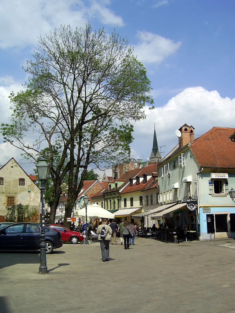 Tkalčićeva Street at Skalinska with trees, historic houses and outdoor terraces