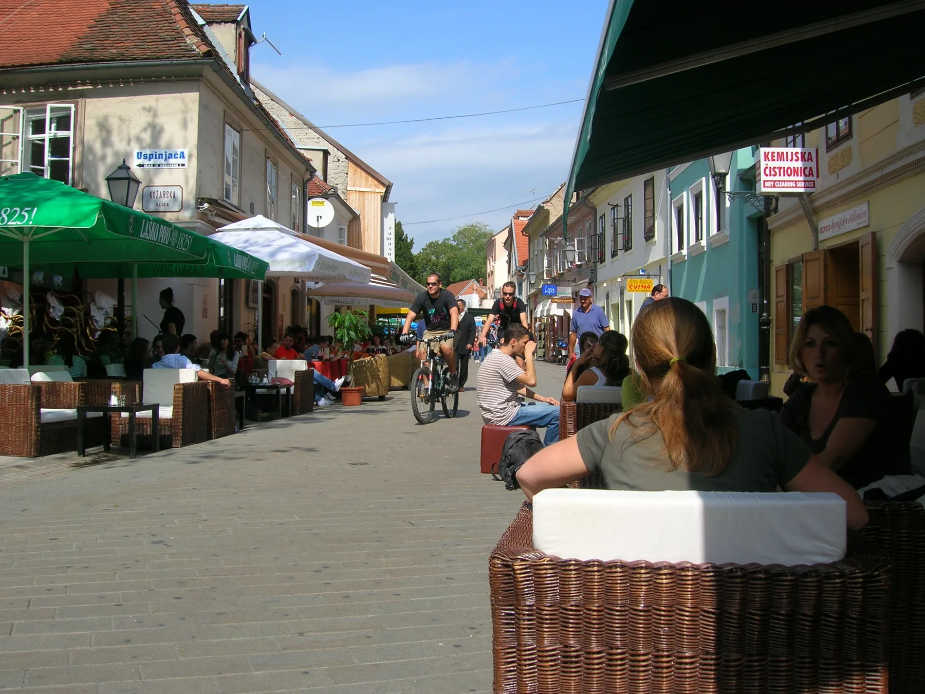 People seated at café terraces along the pedestrian route of Tkalčićeva Street