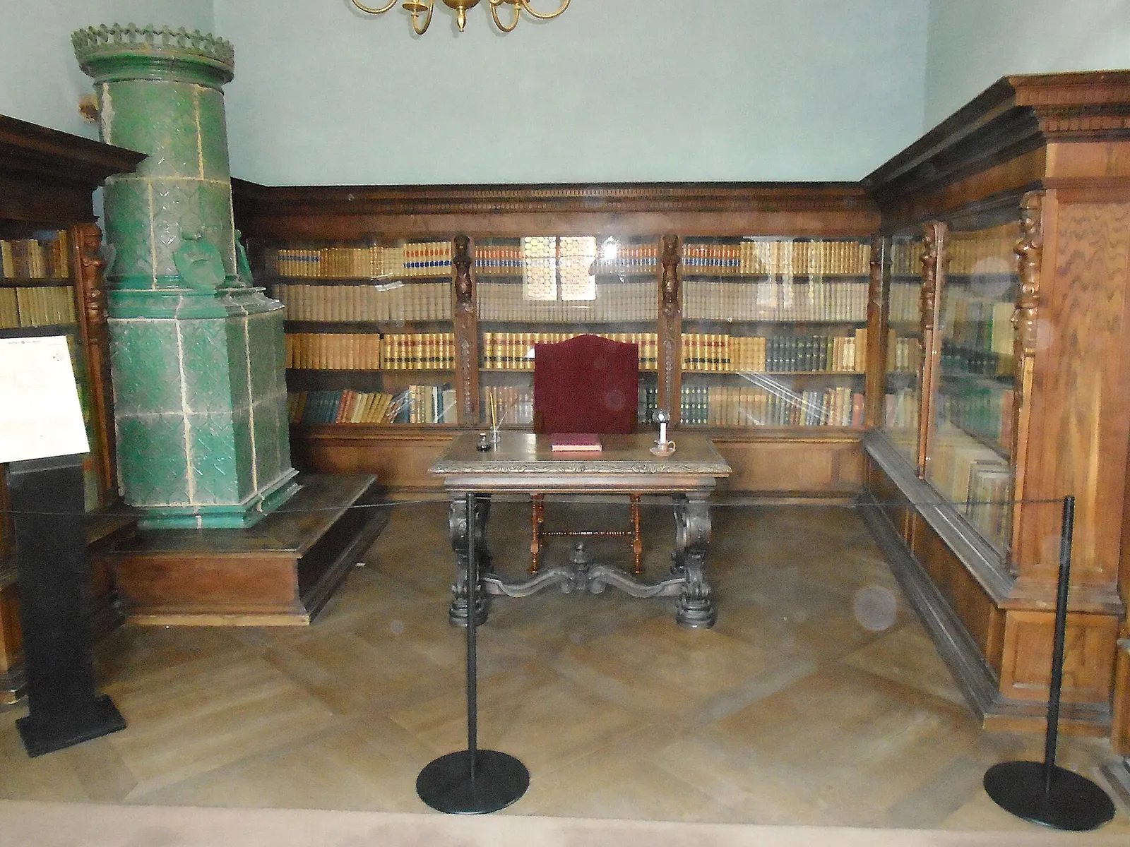 Historic wooden bookcases, tiled stove and desk in the Trakošćan Castle library