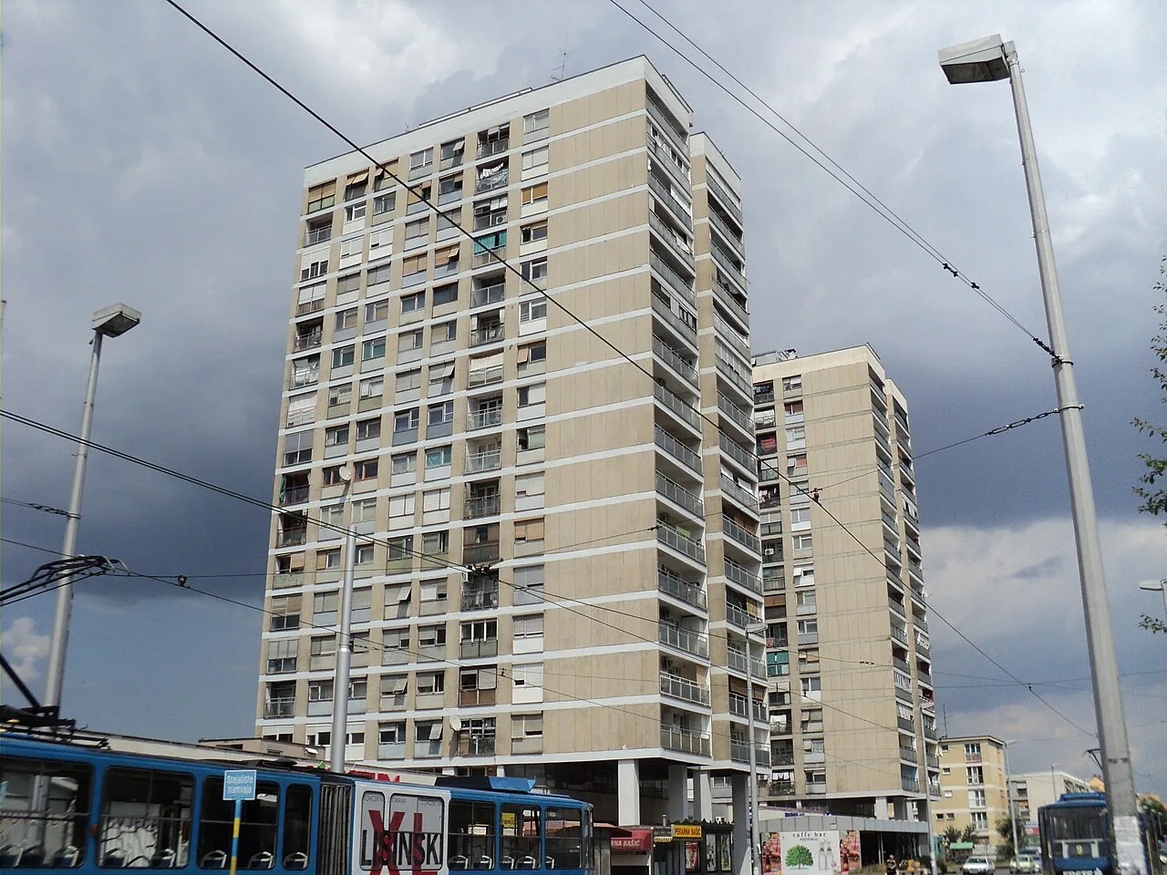 Residential towers, tram wires and a blue tram near Remiza in Trešnjevka