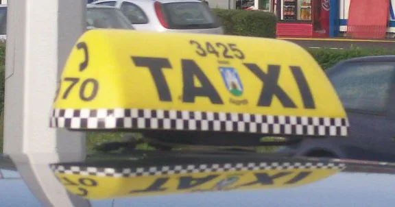 Blue and yellow taxi roof sign photographed in Zagreb