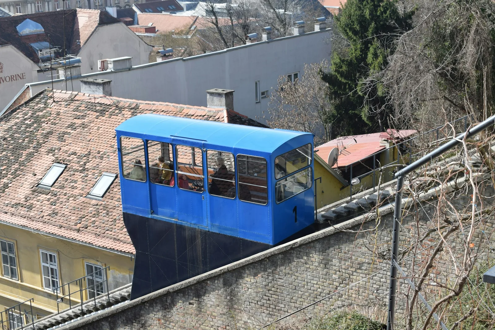 The blue Zagreb funicular climbing beside the Upper Town roofs